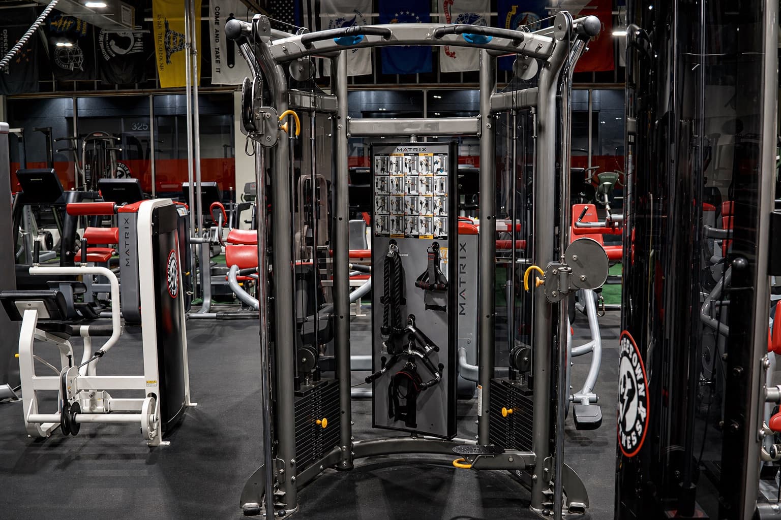 Open gym floor with red padded strength equipment